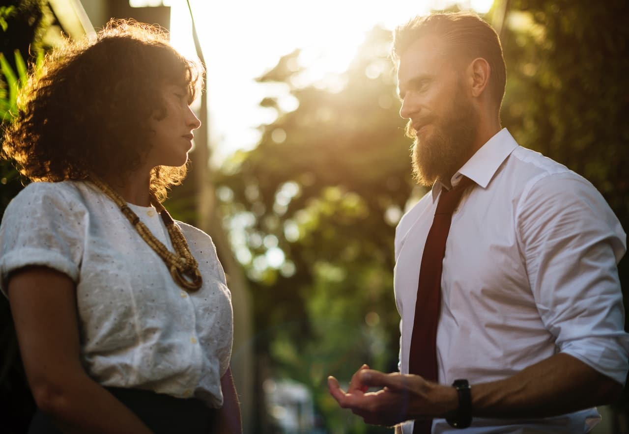 signs a female coworker likes you-making eye contact when smiling in group